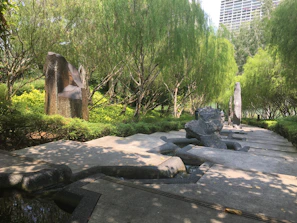 Wide shot of a serene garden space with integrated modern art installations.