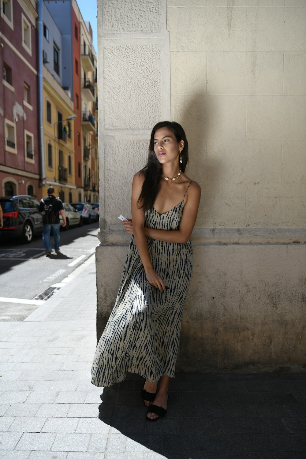 woman leans on wall