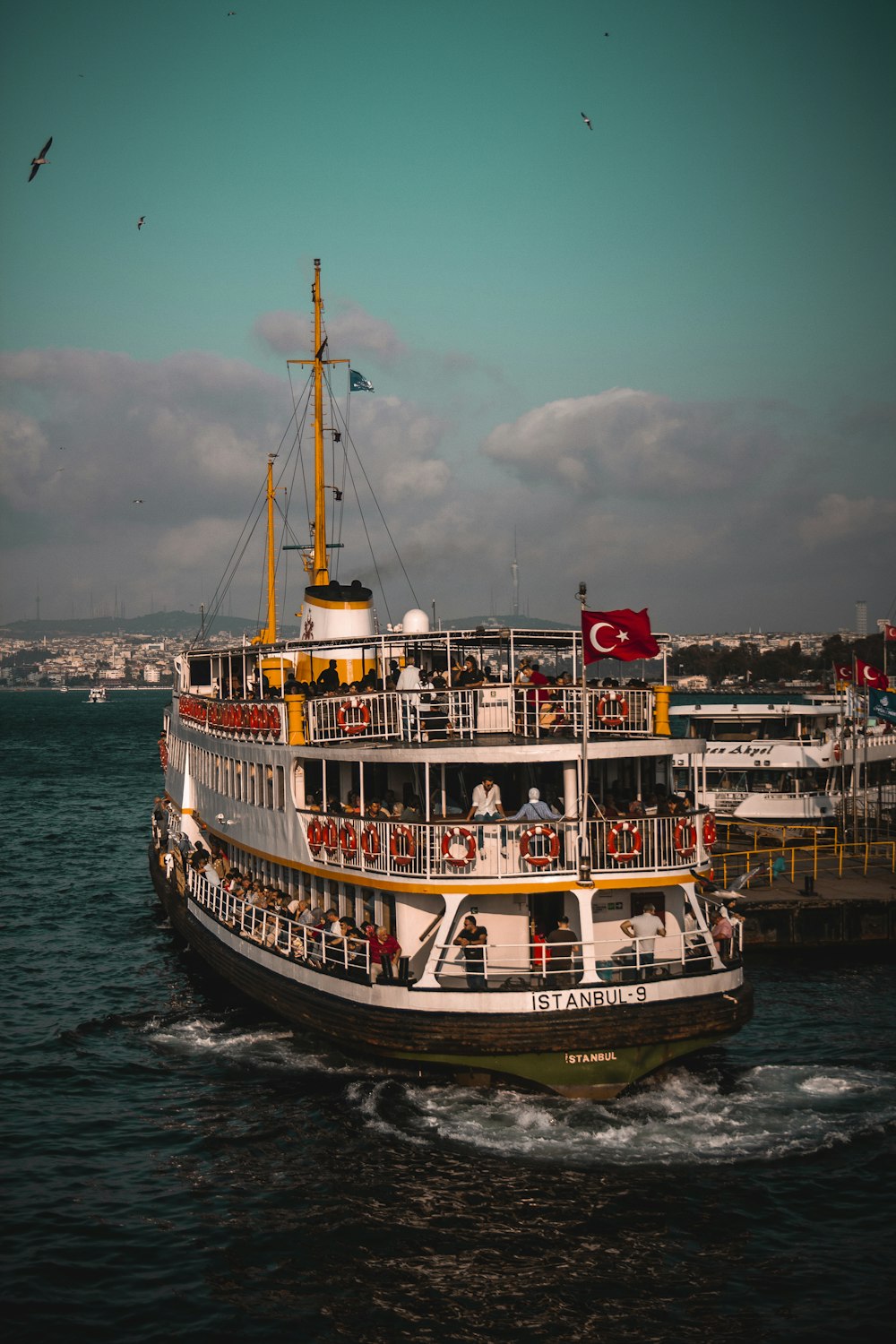 white and red ship with Turkey flag sailing during daytime