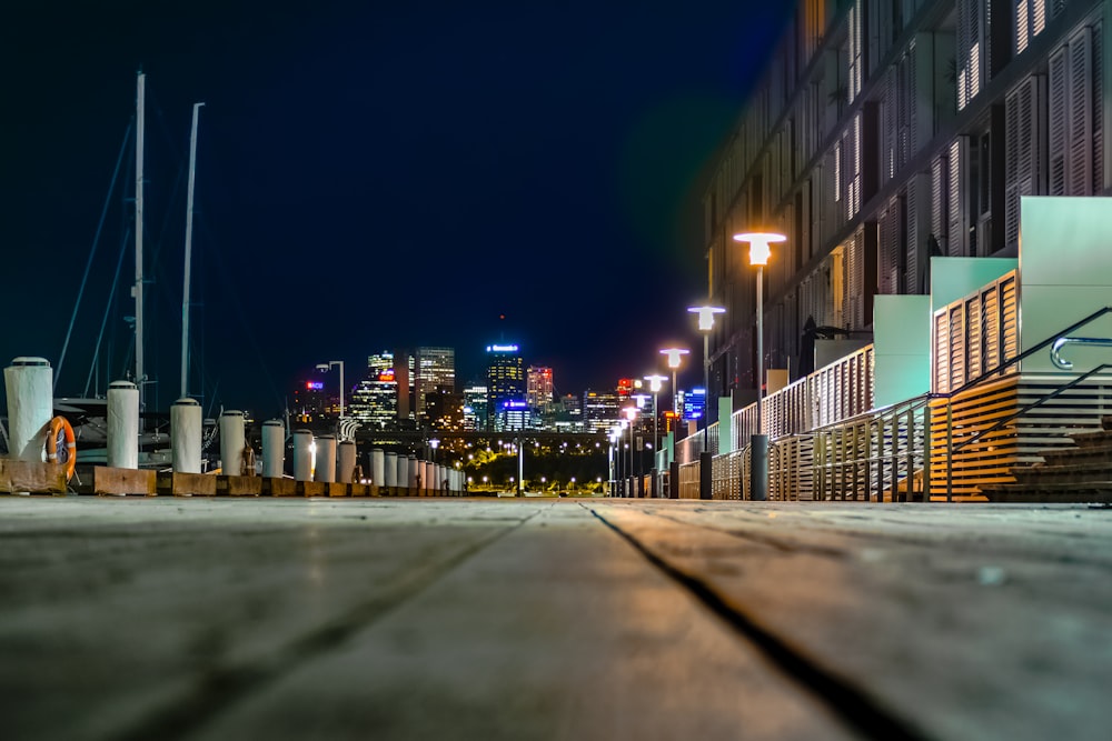 gray concrete road near buildings during night time