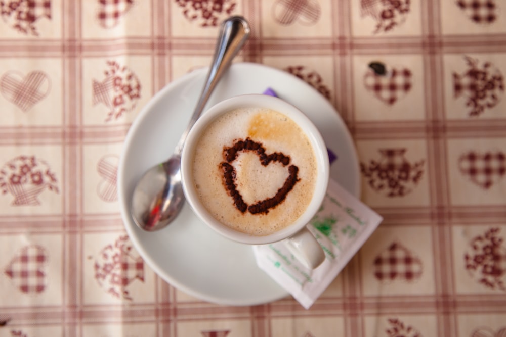 cup of coffee on saucer with spoon