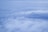 A vast expanse of clouds stretching across the sky, with layers of fluffy white clouds interspersed with soft blue hues. The cloud formations create a serene and peaceful atmosphere, providing a bird's-eye view from above.