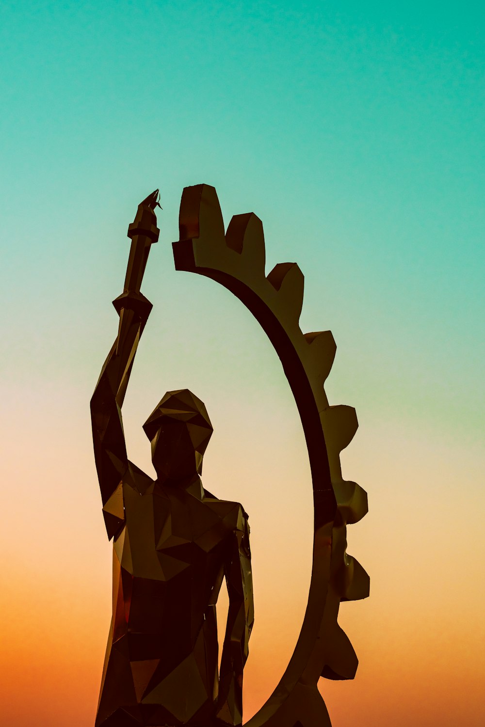 person holding torch statue