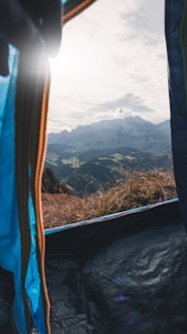 A panoramic view of Yovi Industries' bustling manufacturing facility in Kullu, with skilled workers assembling premium outdoor tents under natural light.