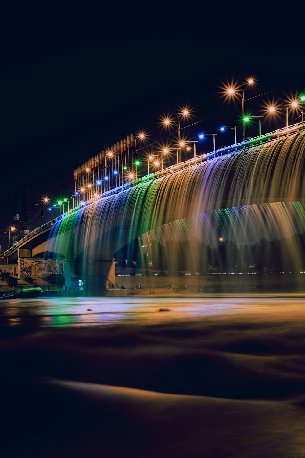 assorted-colored LED lights on gray concrete bridge