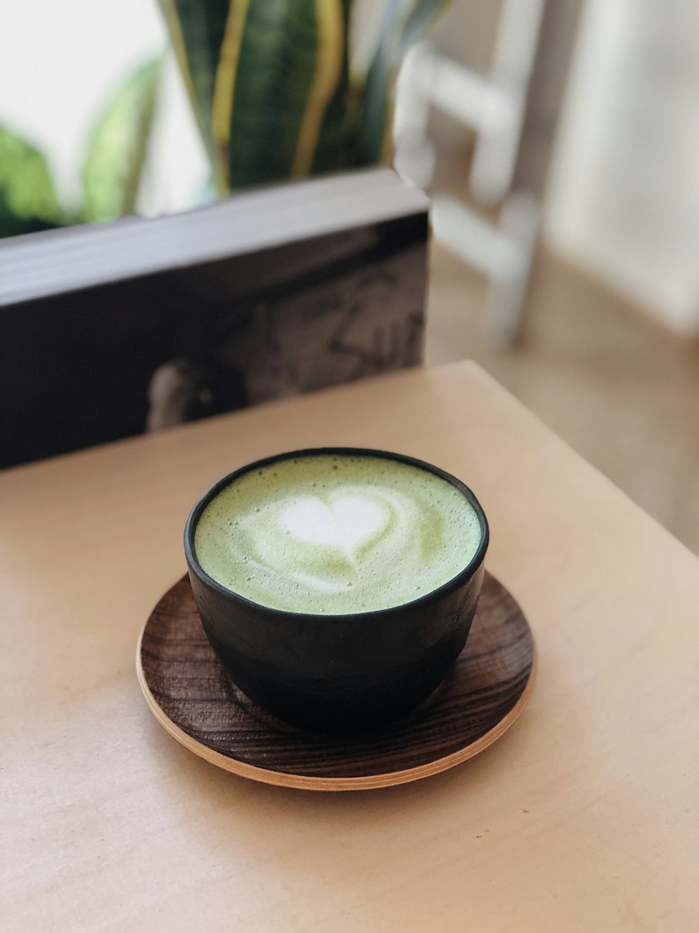 black ceramic cup with brown saucer