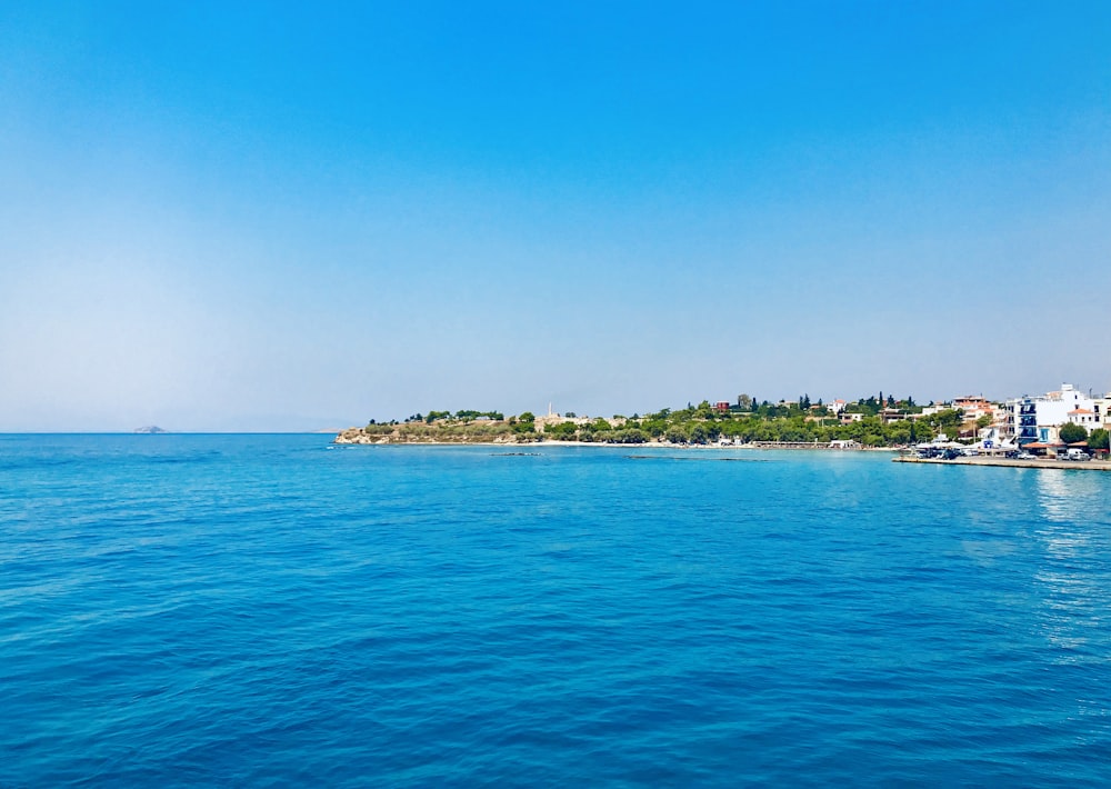 blue body of water under blue sky