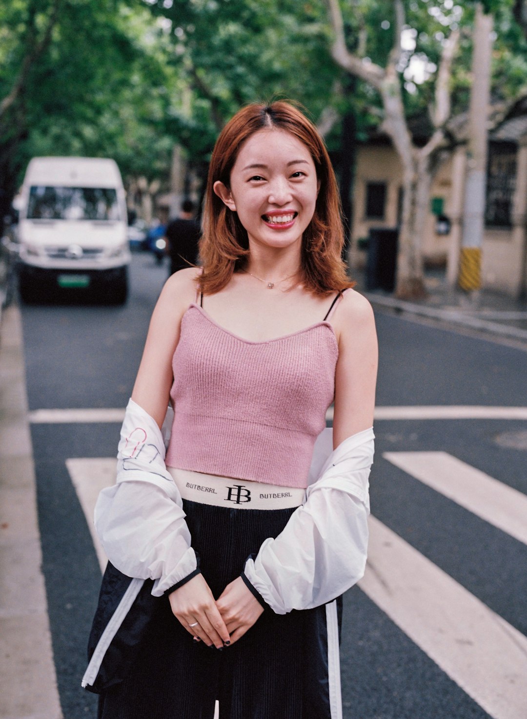 woman in pink top beside pedestrian lane