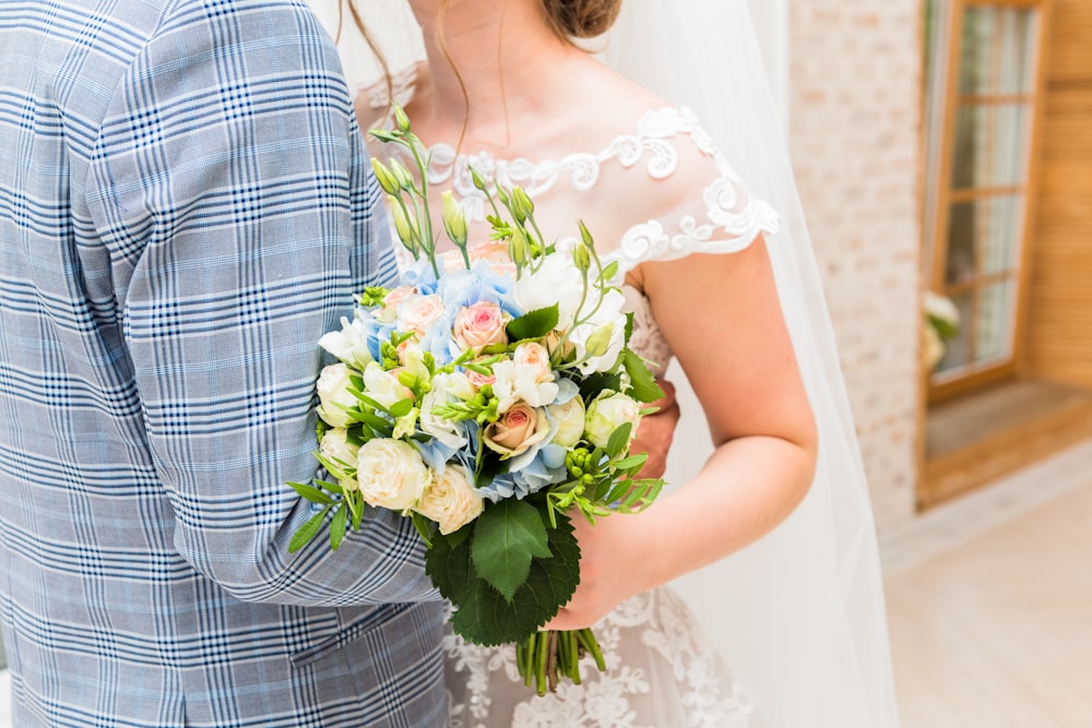 man holding woman in white wedding dress