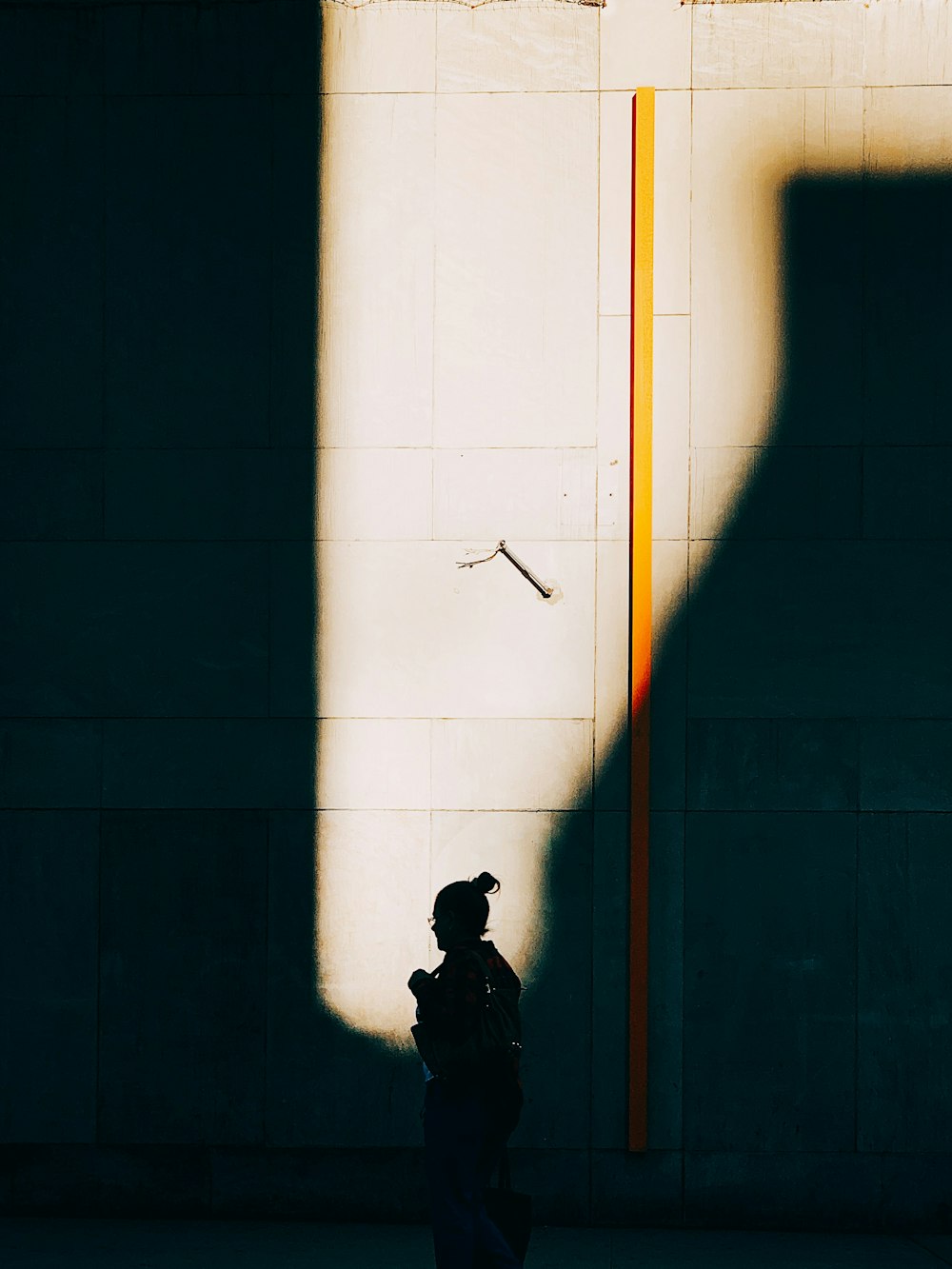 woman walking beside wall
