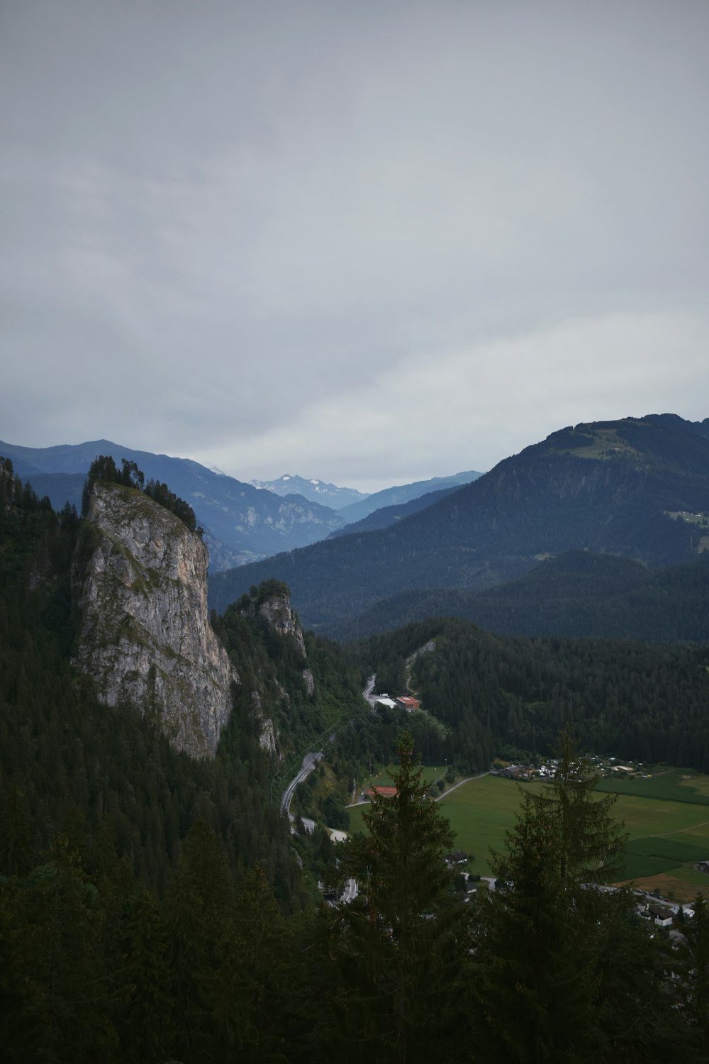 a view of a valley with mountains in the background