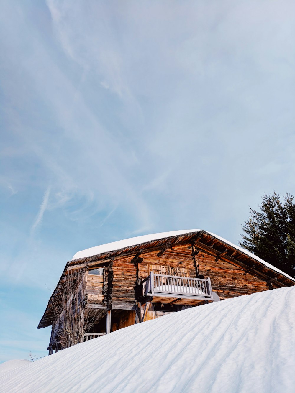 brown wooden house on snow