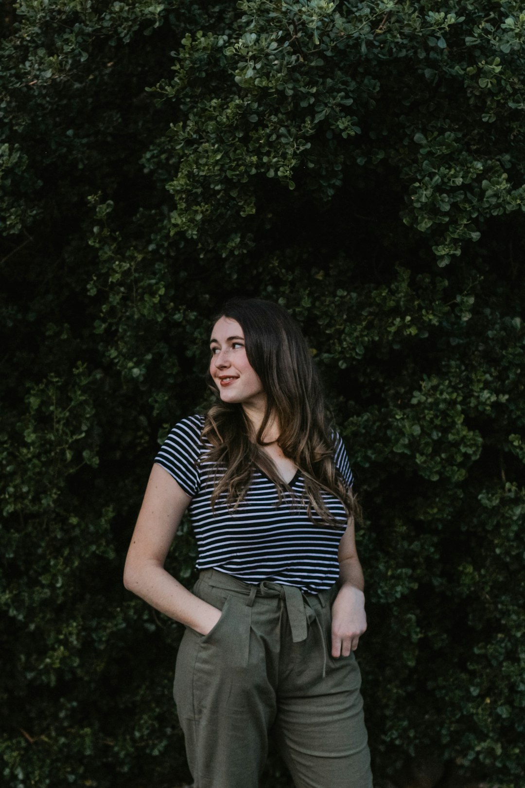 woman wearing black and white striped top and green bottoms