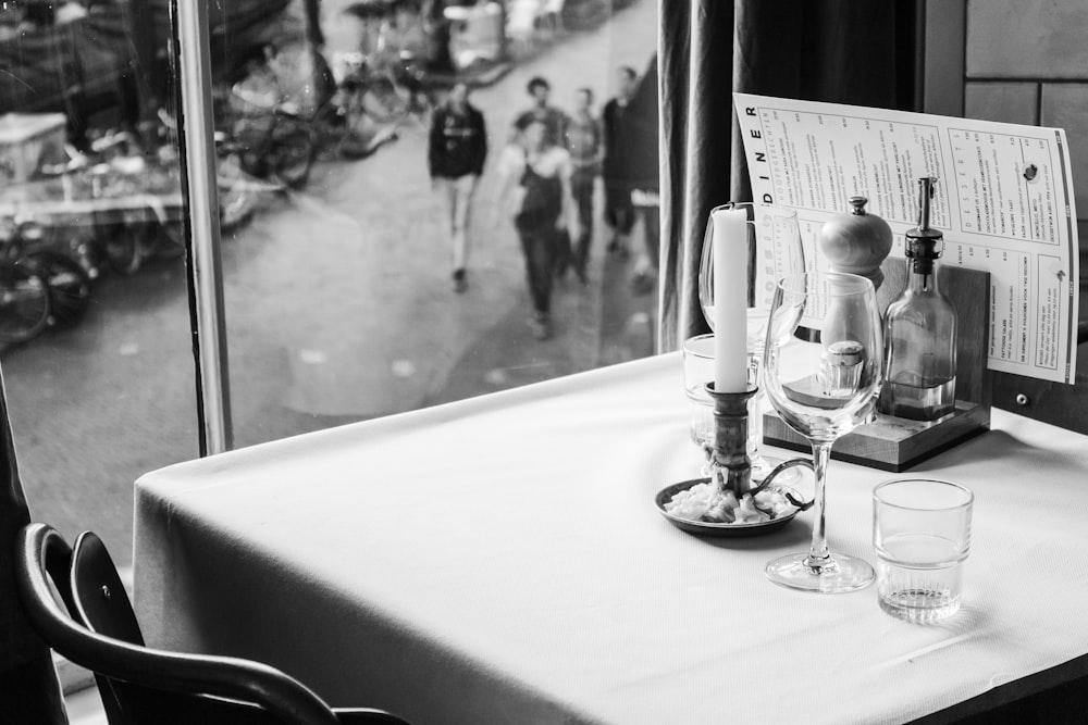 a table with a menu and two glasses on it