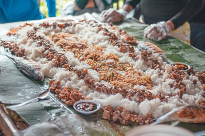 Community members sharing food during a communal event at Musholla Al Muhajirin