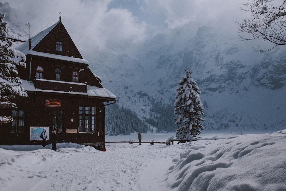 a cabin in the mountains covered in snow