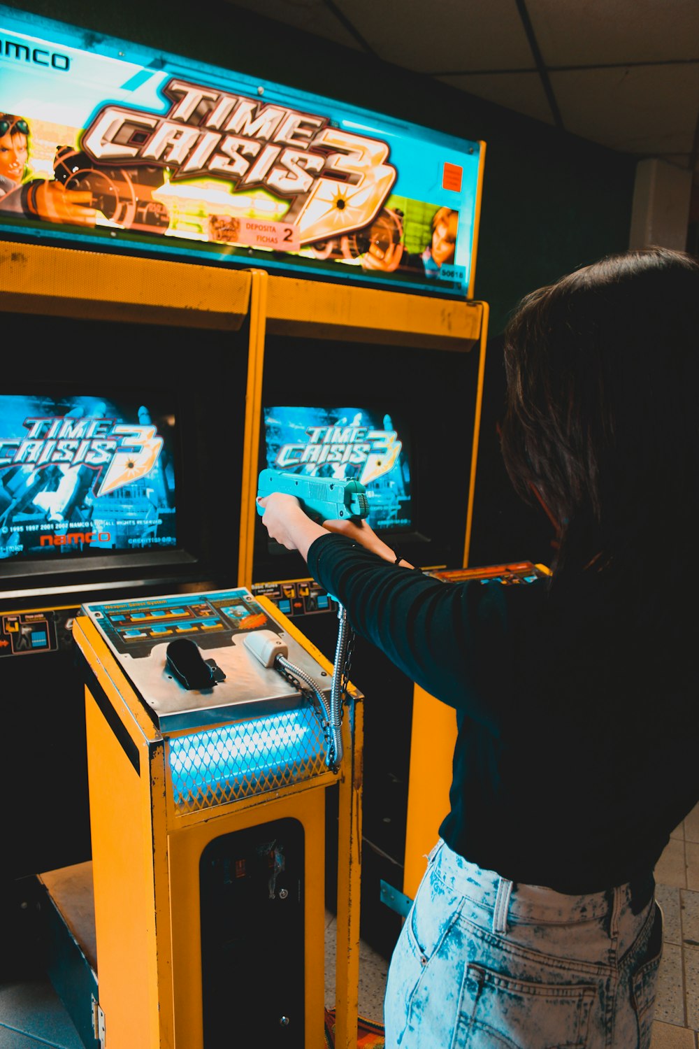 woman playing arcade machine