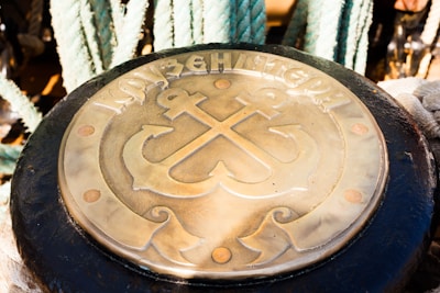 Close-up of a steel certification plaque with maritime and industrial symbols.
