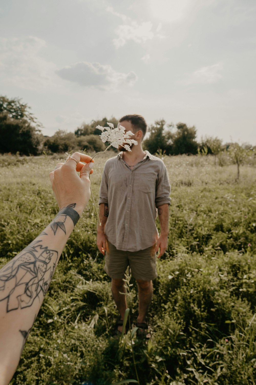 man standing on green grass field