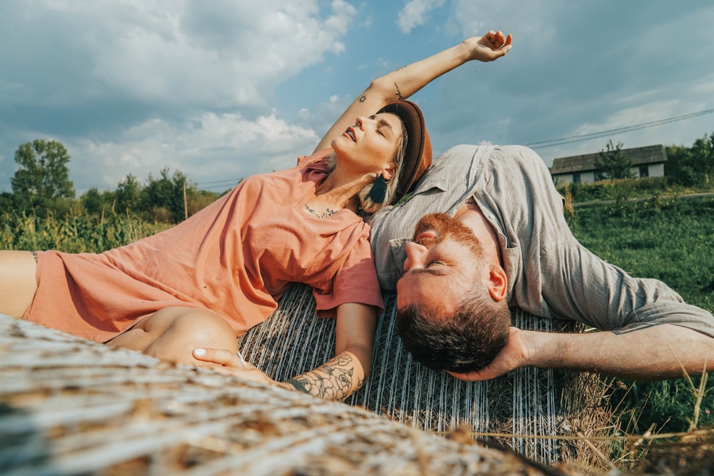 couple lying on grass during daytime