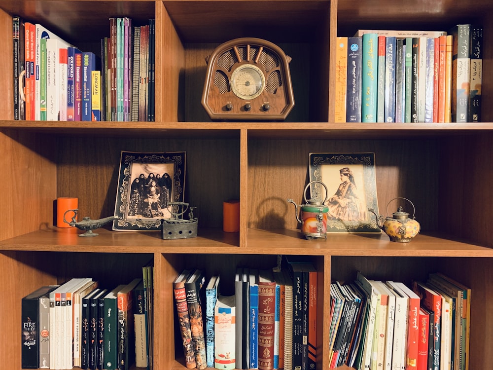 brown wooden bookshelf with books