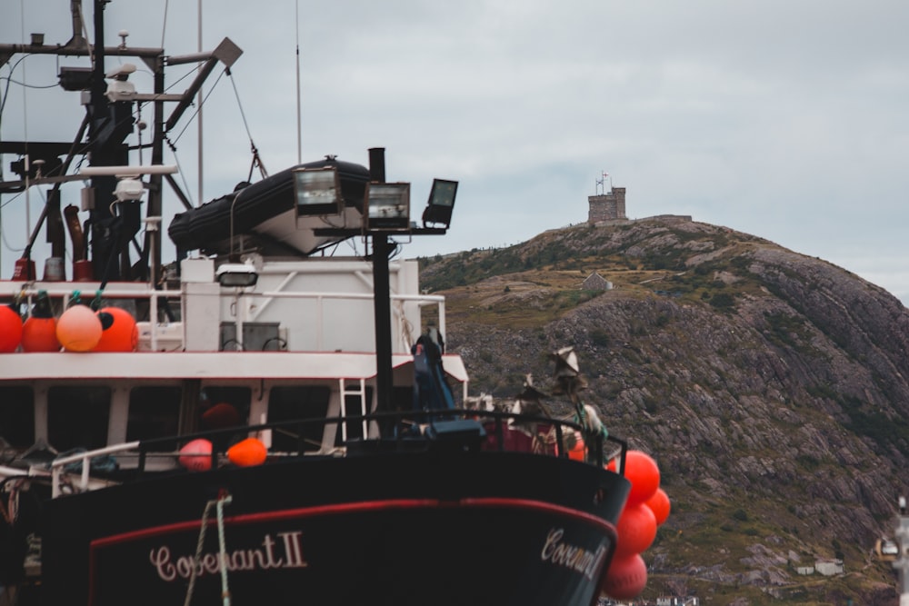 black and white ship near mountain