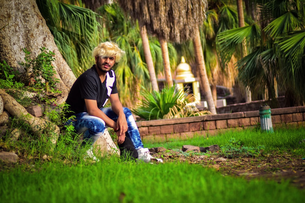 man sitting near tree during daytime