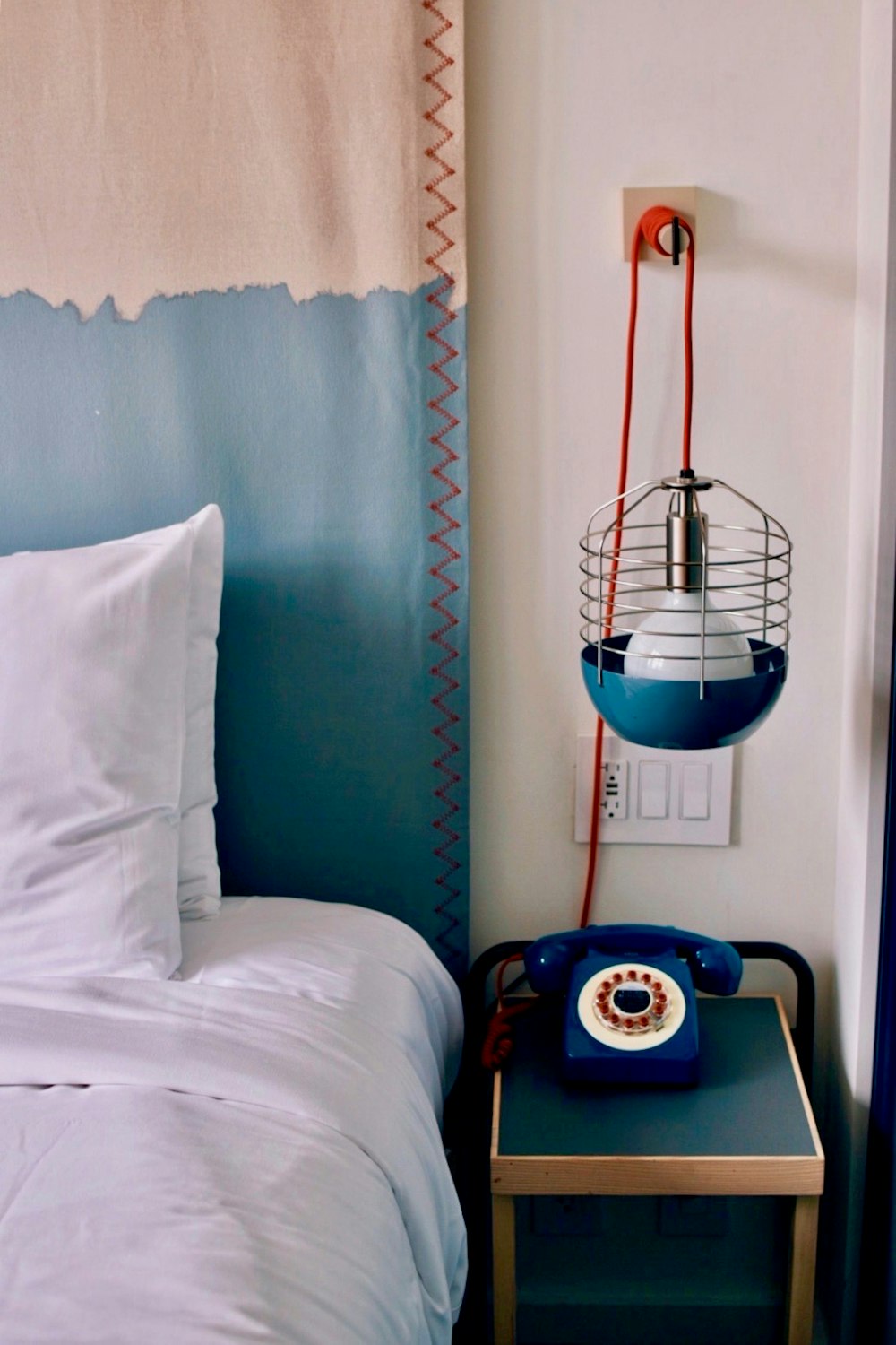 a bed with a blue phone on top of it