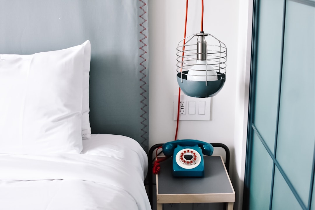 bed near telephone, Boutique hotel bedroom interior.