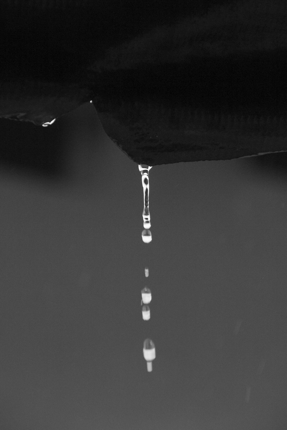 a black and white photo of a water drop