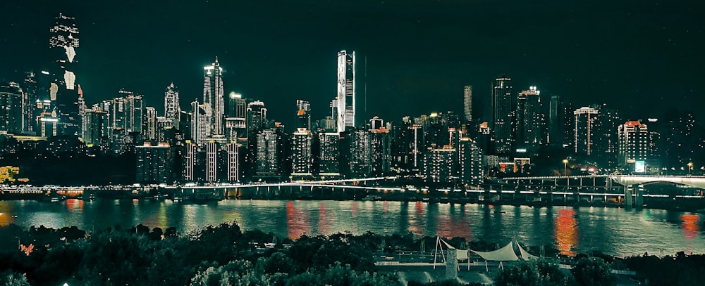 concrete buildings beside body of water