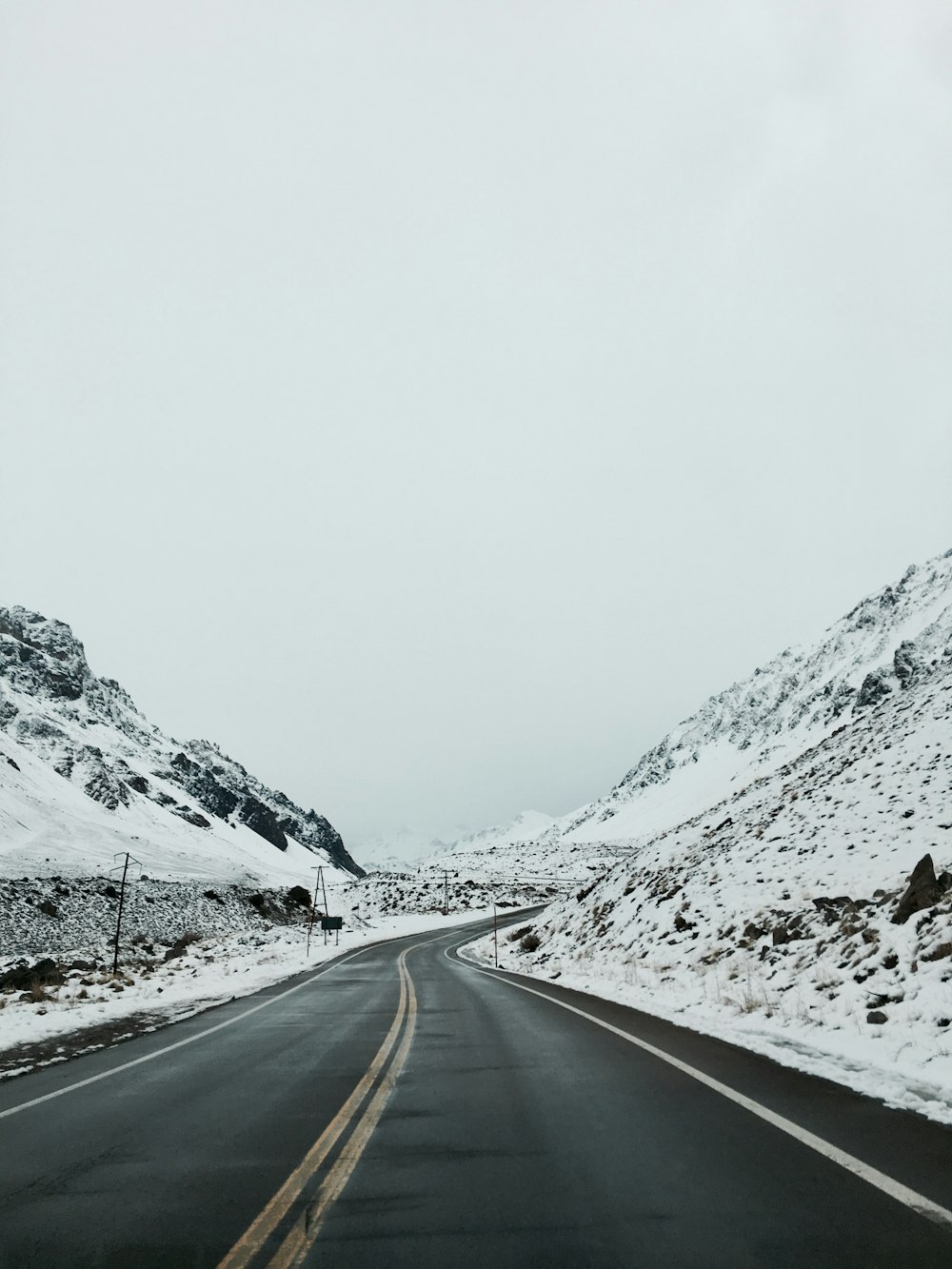 Une route enneigée avec une montagne en arrière-plan
