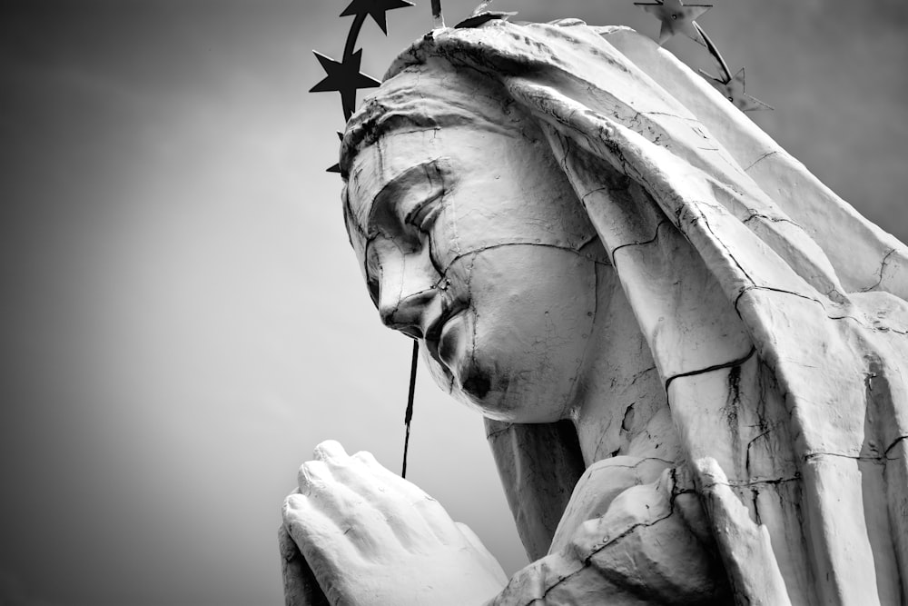 grayscale photo of Virgin Mary statue