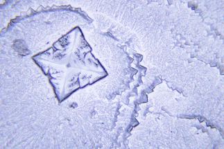 A detailed diagram showing angular momentum vectors interacting within a crystal lattice.