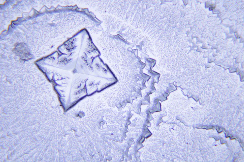 A detailed diagram showing angular momentum vectors interacting within a crystal lattice.