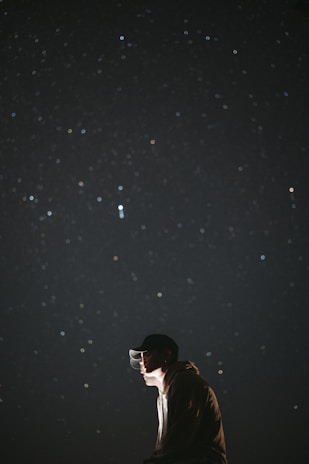 Close-up of a hoodie featuring a bold European star emblem glowing softly in twilight.