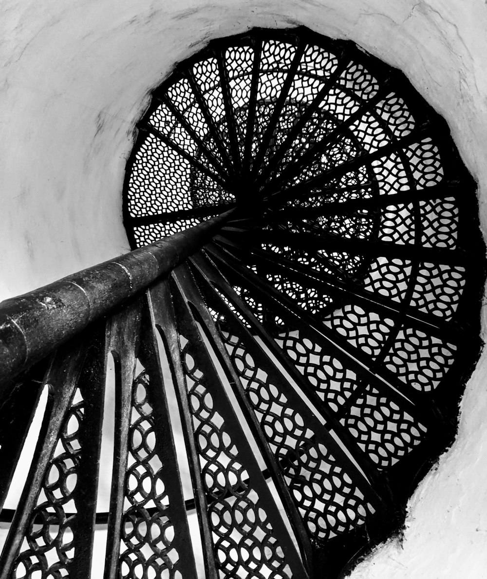grayscale photography of spiral stairs