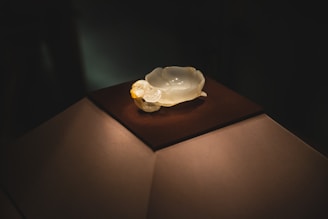 Close-up of a delicate borosilicate glass bunny sculpture glowing softly under natural light.