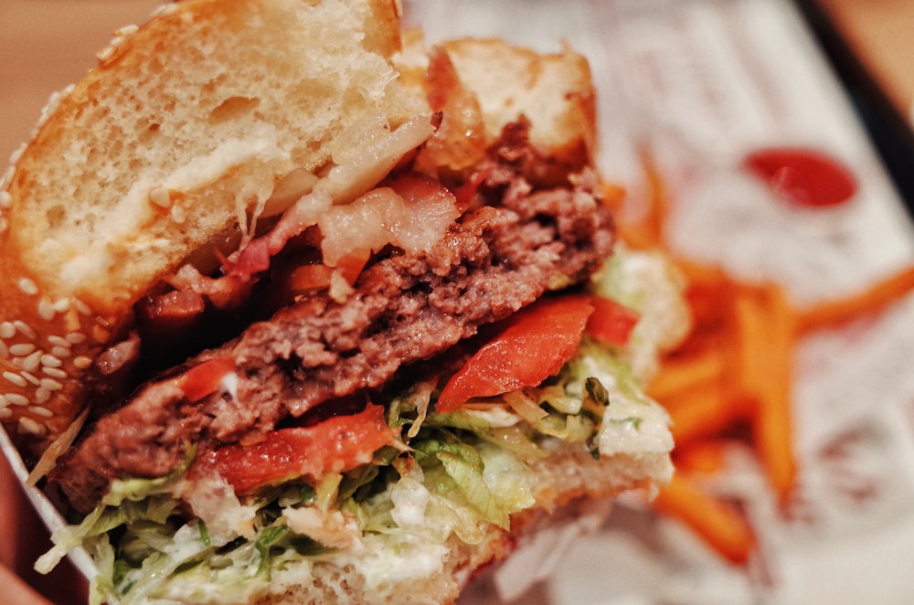 a close up of a person holding a sandwich