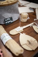 Close-up of natural luffa sponges arranged next to handmade macrame accessories on a wooden surface