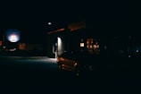 A quiet city street at night with a private car waiting for pickup.