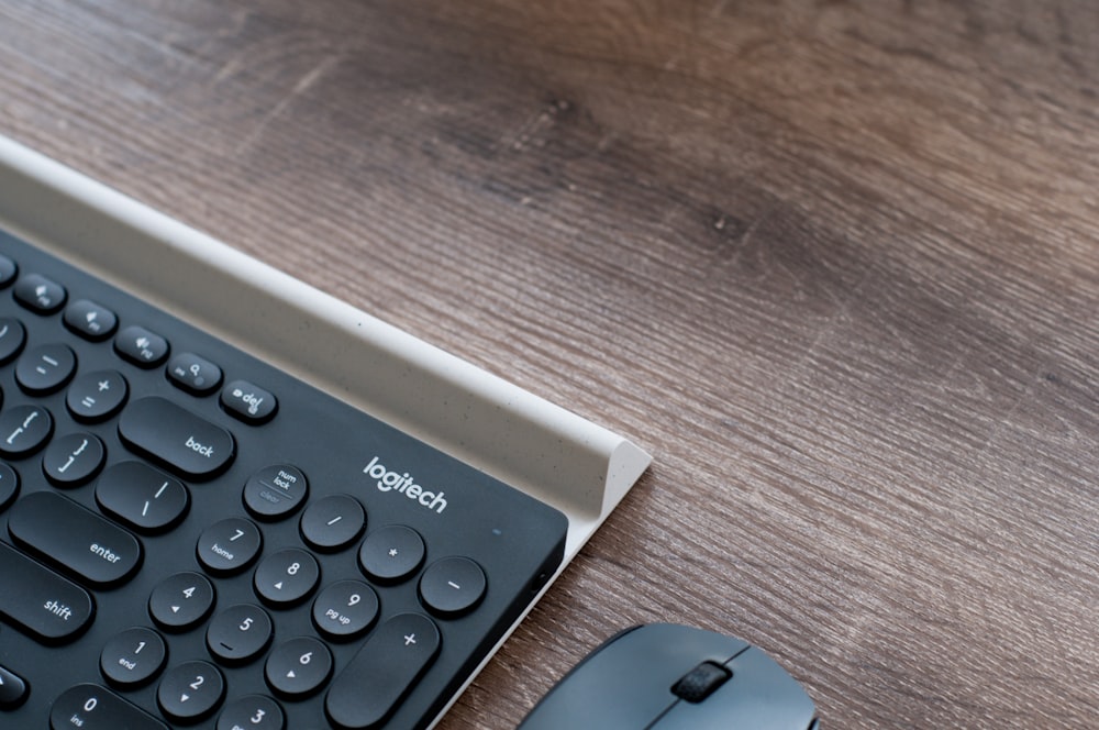 black Logitech keyboard beside mouse