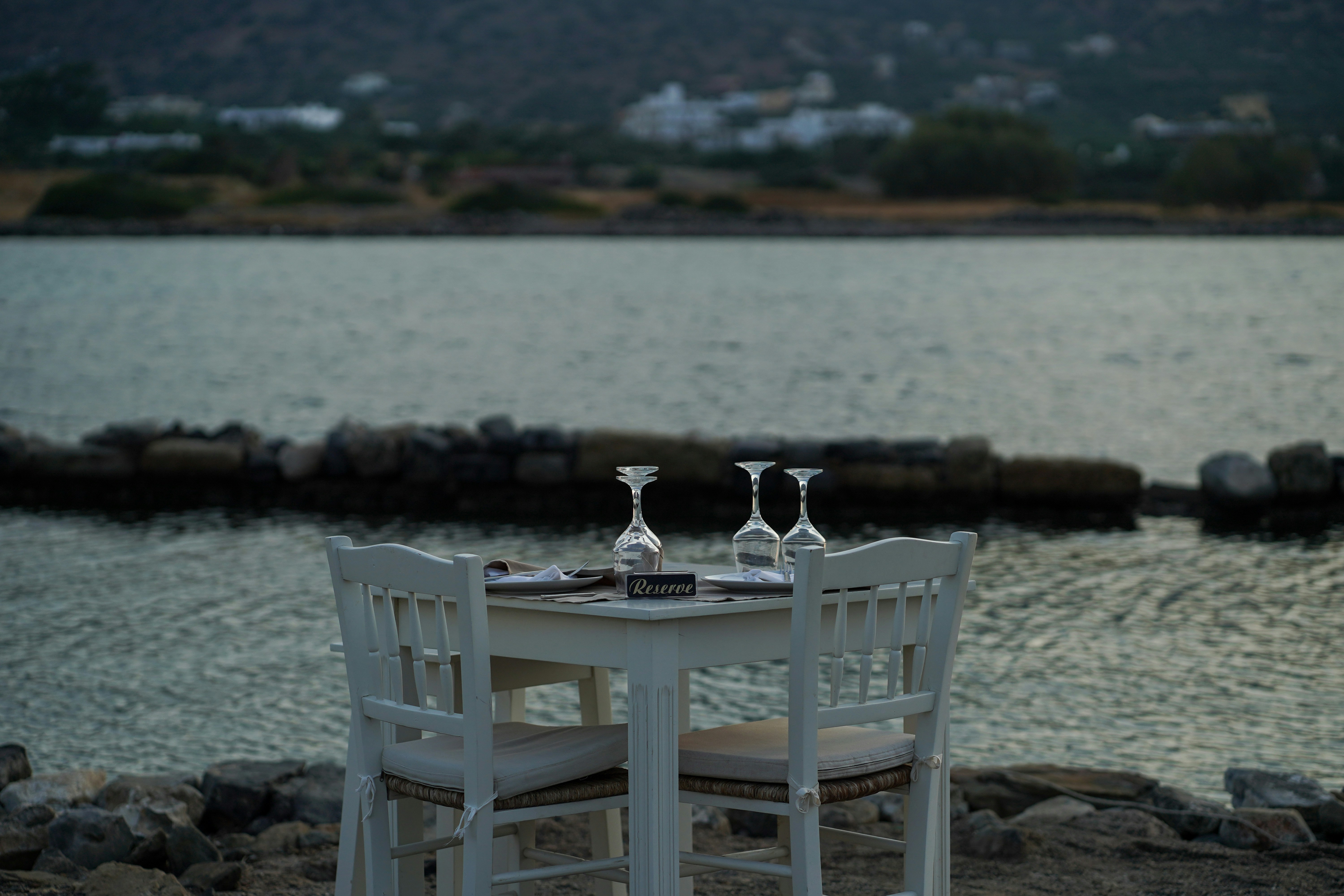 a couple of white chairs sitting next to a table