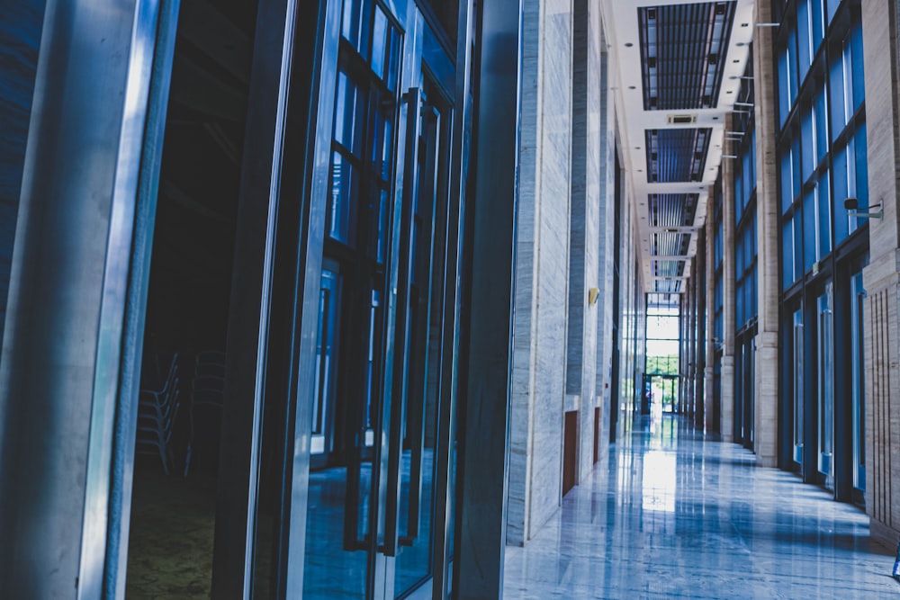 a long hallway with glass doors leading to another building