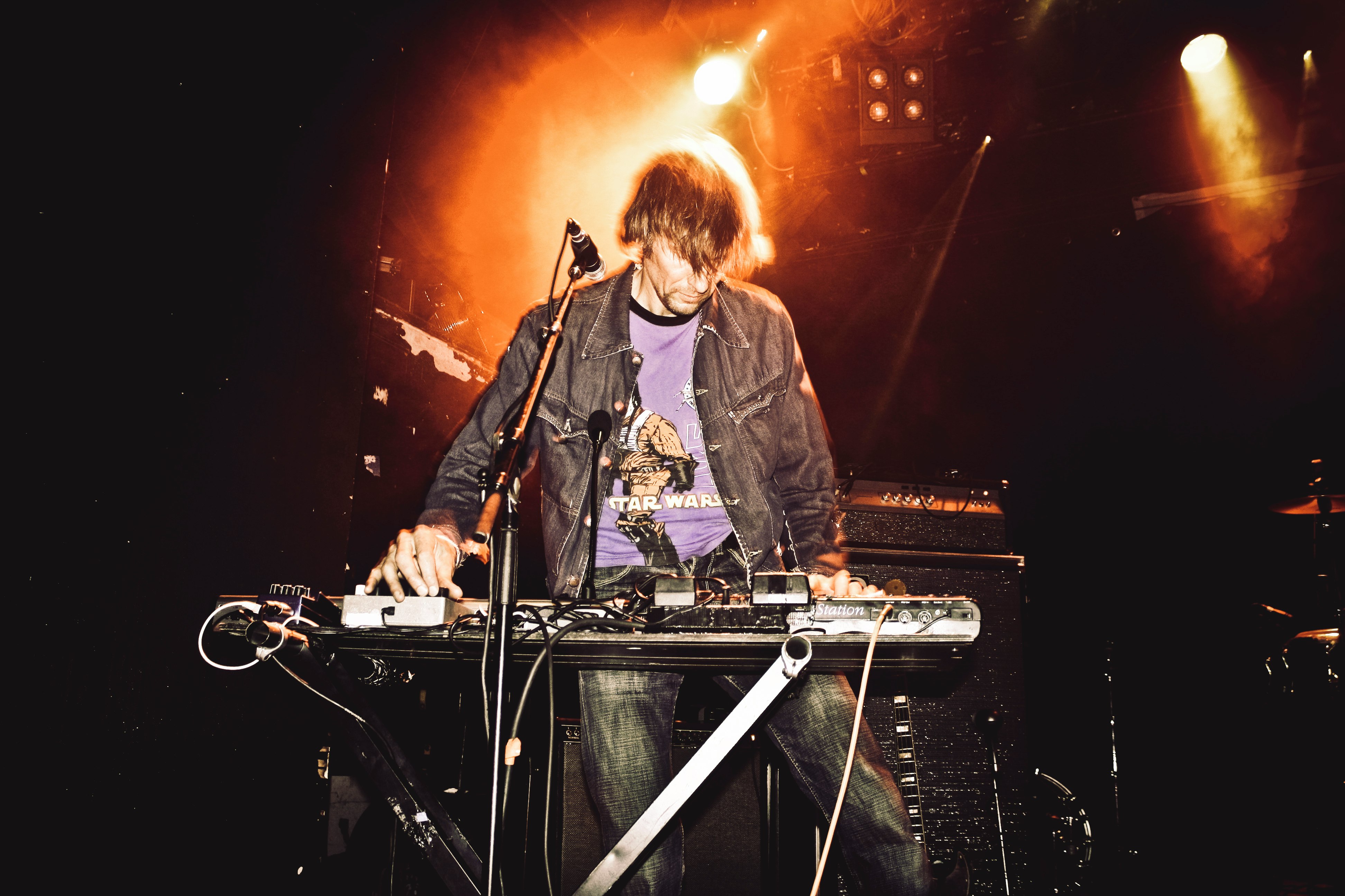 man playing electronic keyboard on stage