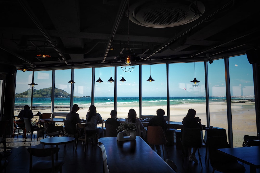 people on restaurant facing blue beach