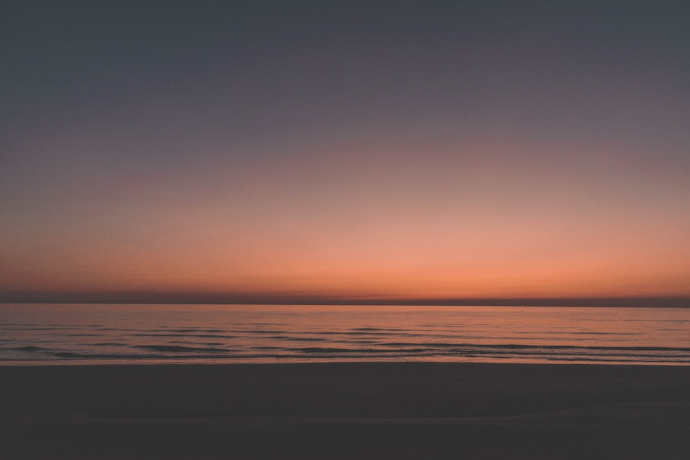 calm body of water during golden hour