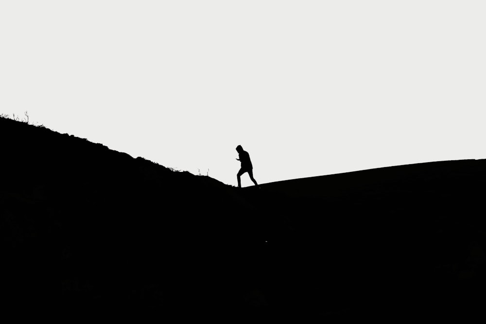 man walking on hill