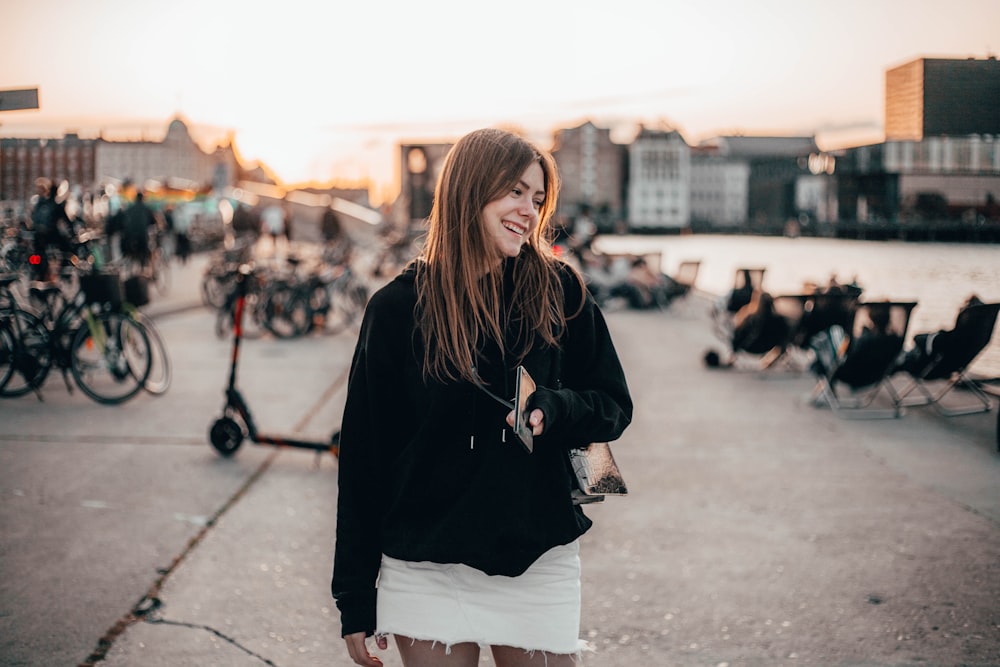 woman standing near bicycles and chairs