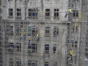 A serene Bali villa under renovation with workers and scaffolding.